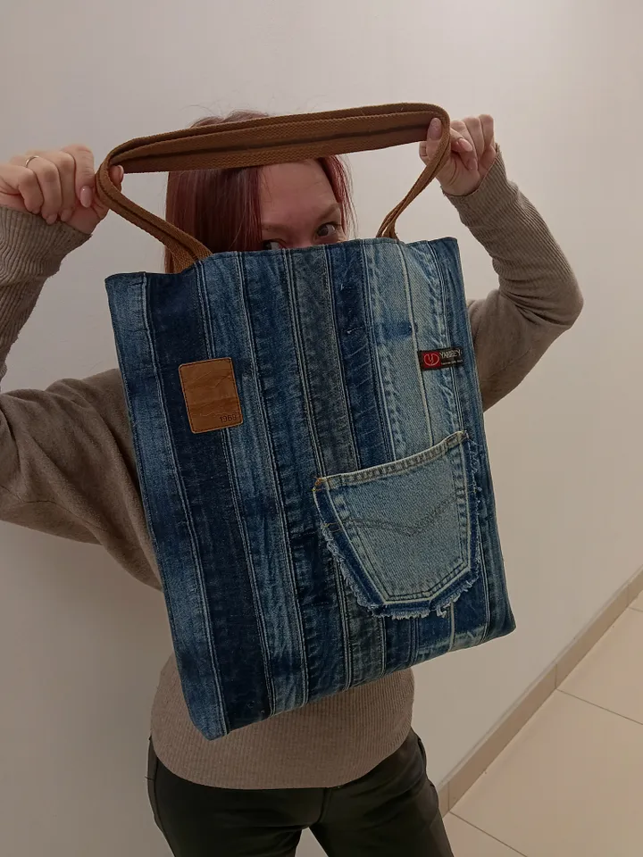 Large denim shopper, shopping bag, city bag, made from recycled jeans, with comfortable handles 60 cm long. Comfortable to wear on the shoulder. Bag with lining made of black synthetic fabric, 2 pockets and strong handles made of 2-color straps. The front