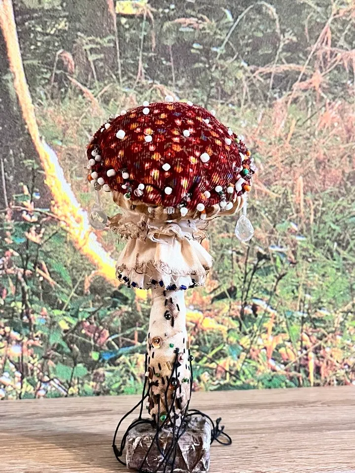 Art doll Mushroom. Unusual handmade figurine. Sleeping child-toy in the image of a fly mushroom. Unique statuette is made of fabric and polymer clay, decorated with beads and beads. An art object for your interior and collection