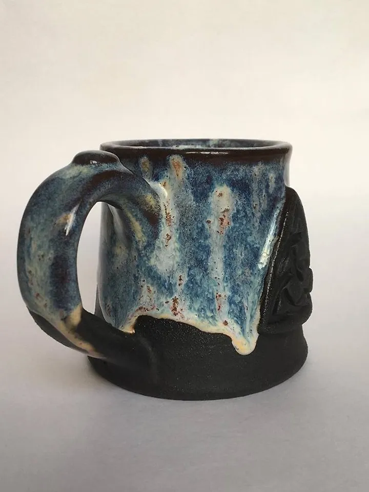 Trinity knot Triquetra in circle blue and black galaxy glazed stoneware mug