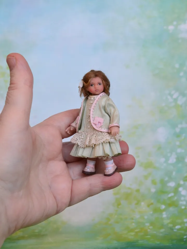 Miniature girl doll for Victorian dollhouse in 1/12 scale.