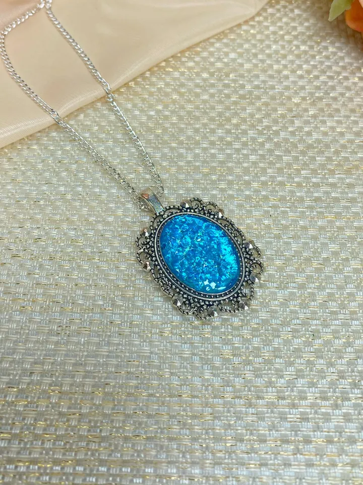 Bright, turquoise pendant on a handmade cord. Handmade jewelry with turquoise rhinestones.