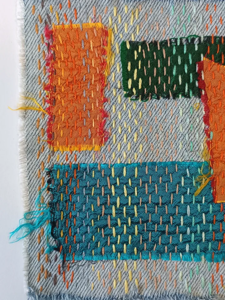 Upcycled denim boro patch – visible mending.