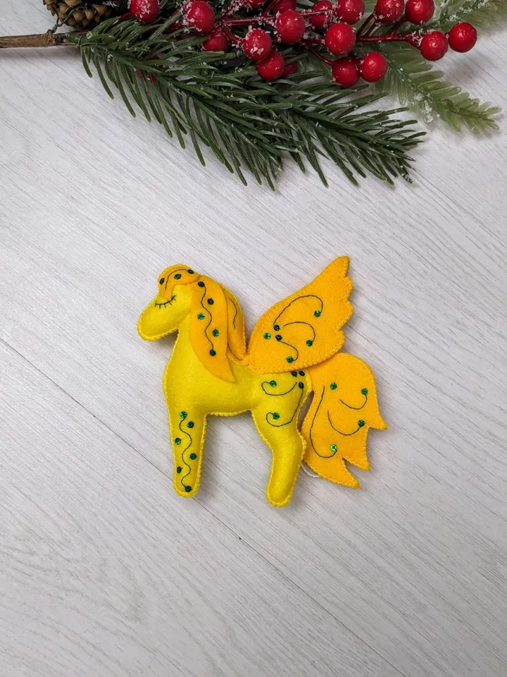 Pegasus in ancient Greek mythology is a winged horse, a favorite of the muses. Yellow felt toy Pegasus
