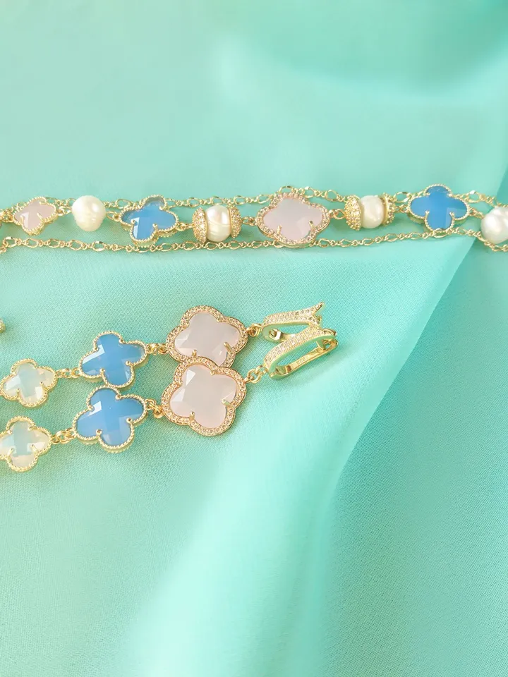 A set of jewelry of a grown-blue with gilding and natural pearls