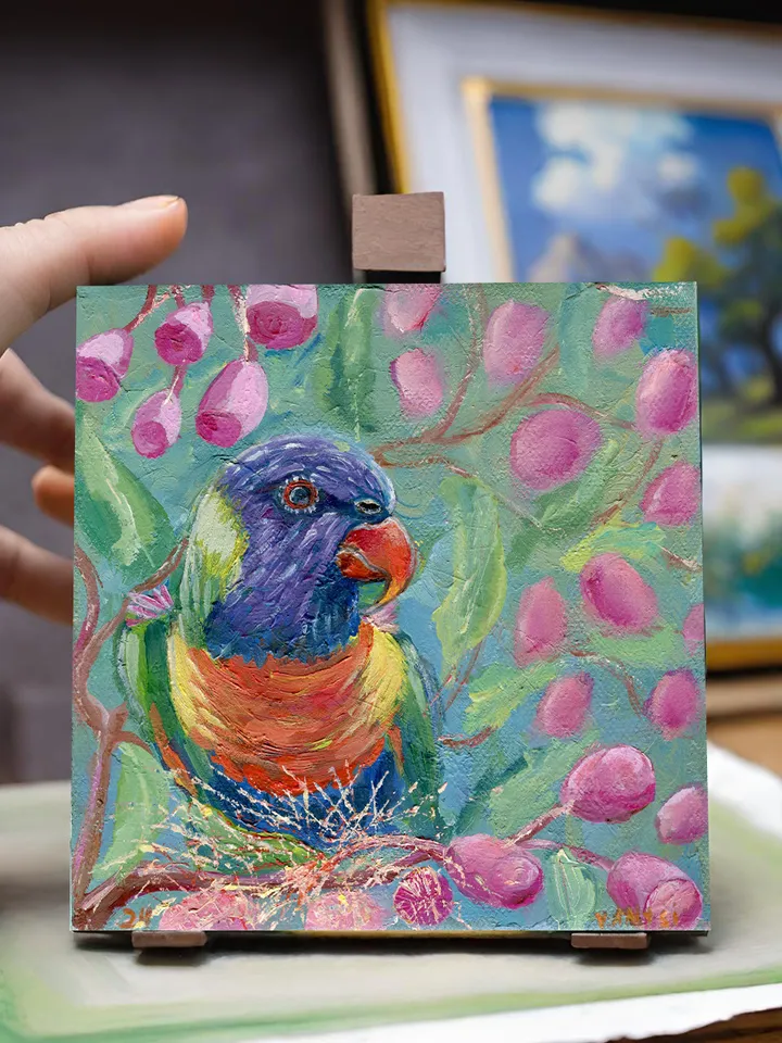 Parrot sits on a branch of a flowering tree