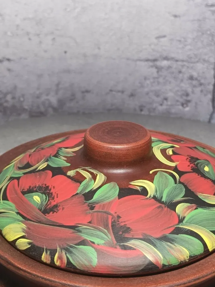 Ceramic casserole with a lid. Handmade from red clay. Carved pattern