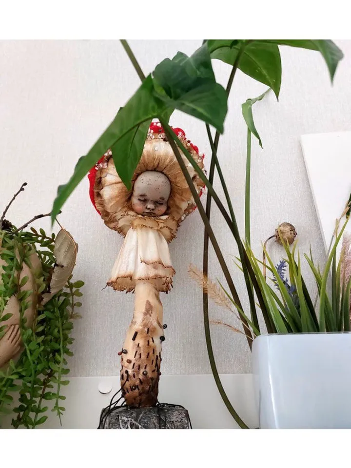 Art doll Mushroom. Unusual handmade statuette. Sleeping child-toy in the image of a fly mushroom. Mushroom is a textile sculpture. Unique statuette made of fabric and polymer clay, decorated with beads and beads. An art object for your interior and collec