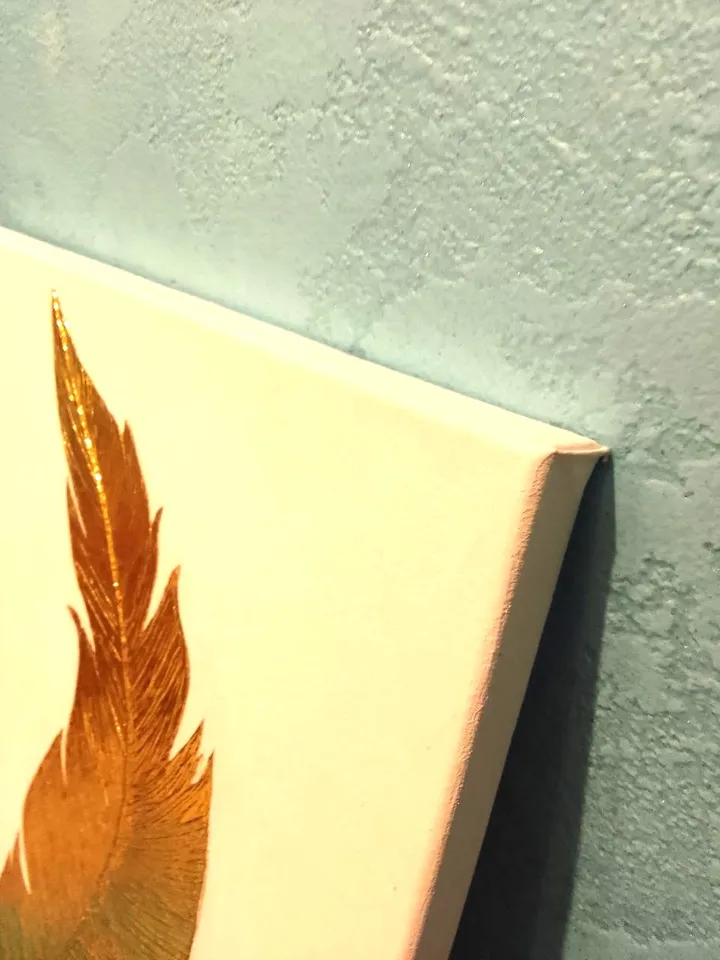 “Golden Feather on a White Background” is a painting that will add luxury to your interior
