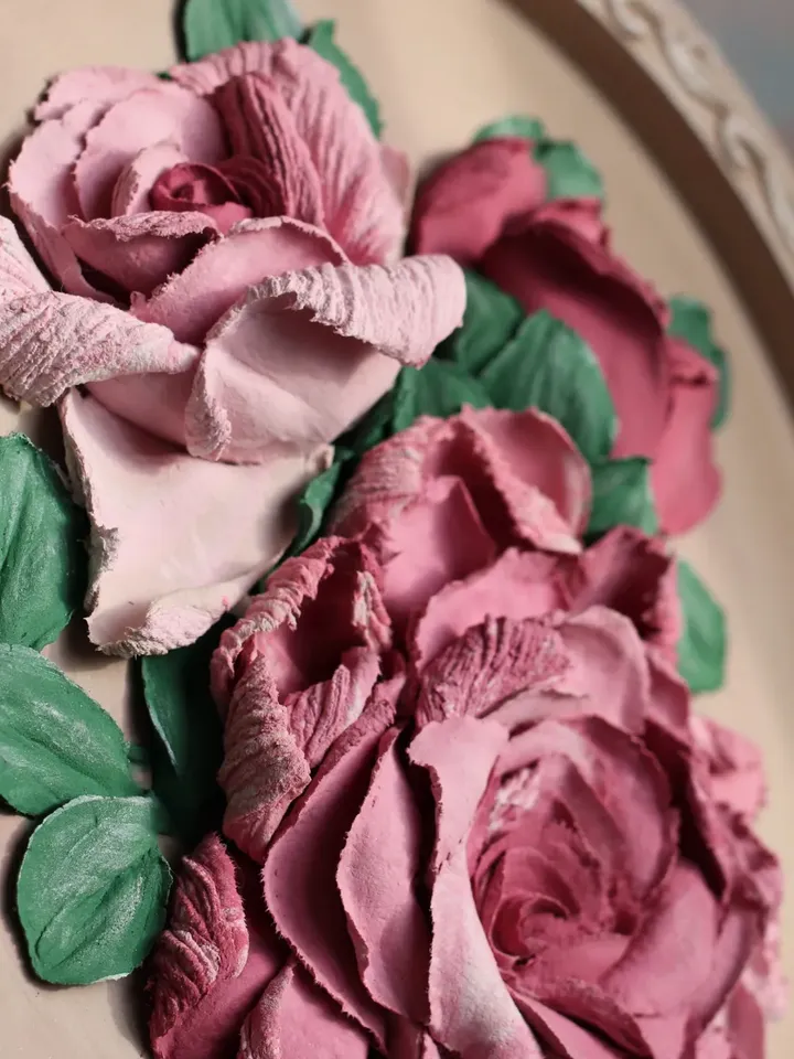 Round decorative panel with volumetric roses, decorative plaster, sculptural painting