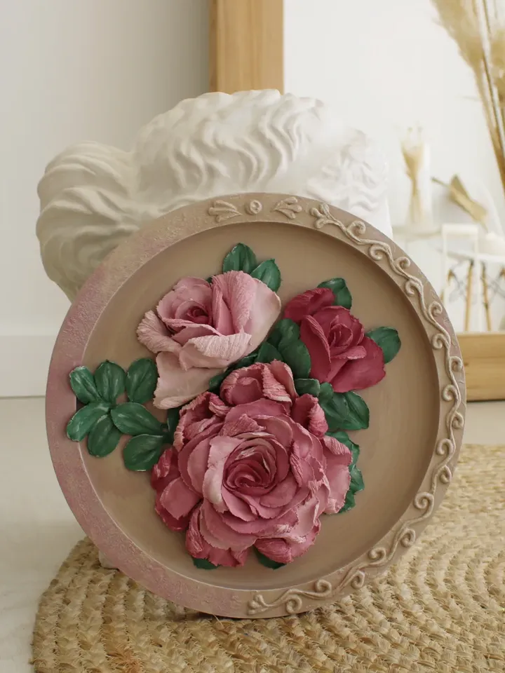 Round decorative panel with volumetric roses, decorative plaster, sculptural painting