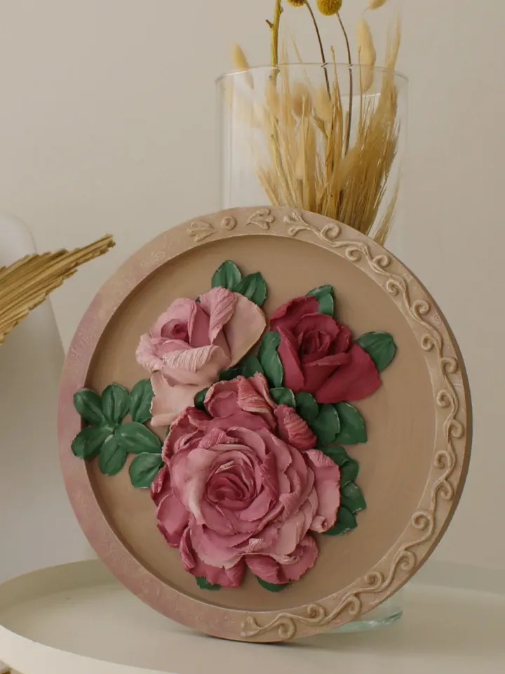 Round decorative panel with volumetric roses, decorative plaster, sculptural painting