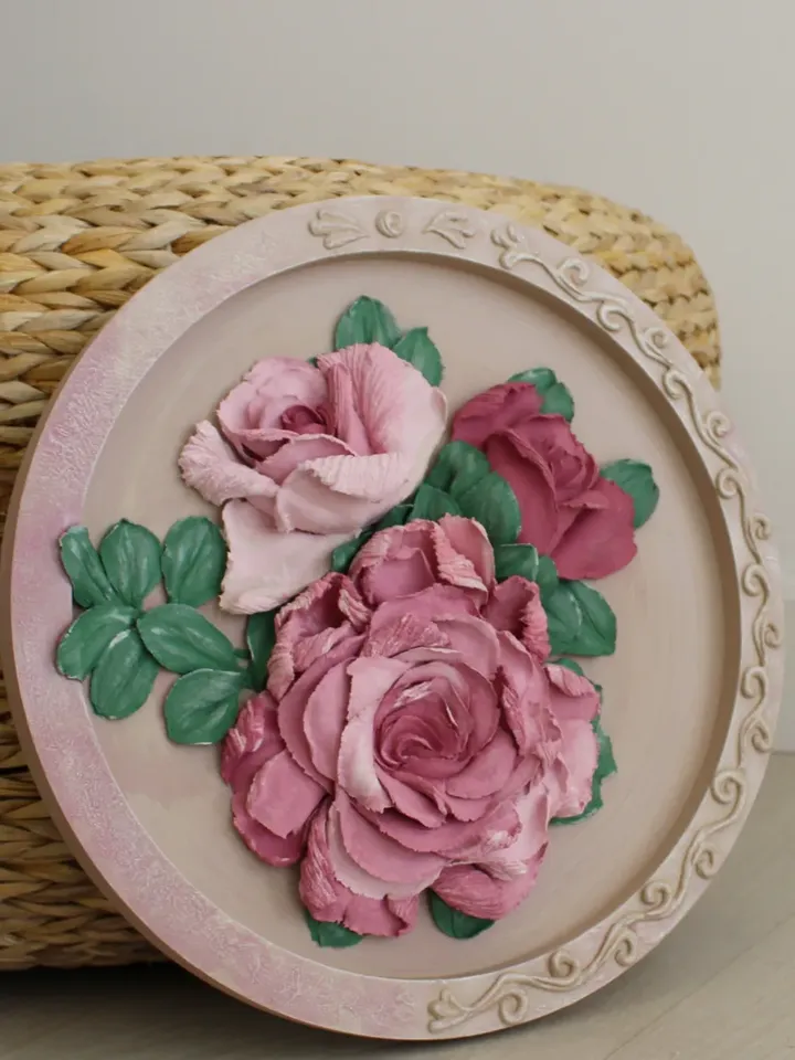 Round decorative panel with volumetric roses, decorative plaster, sculptural painting