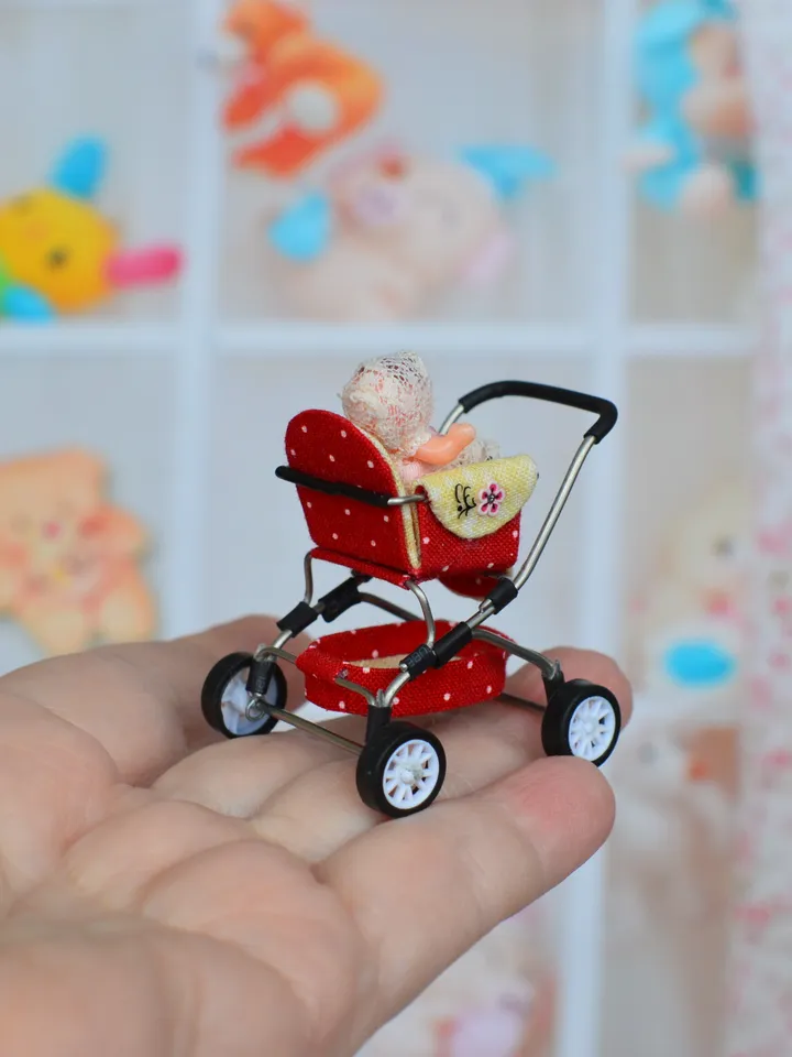 Miniature toy doll stroller in 1/24 scale. Complete with baby doll. Red handmade stroller.