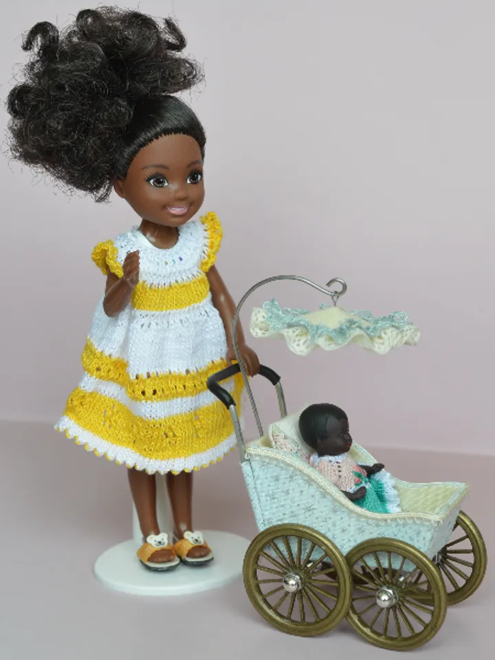 Miniature toy stroller for a little doll. Pram for the little poopsie.