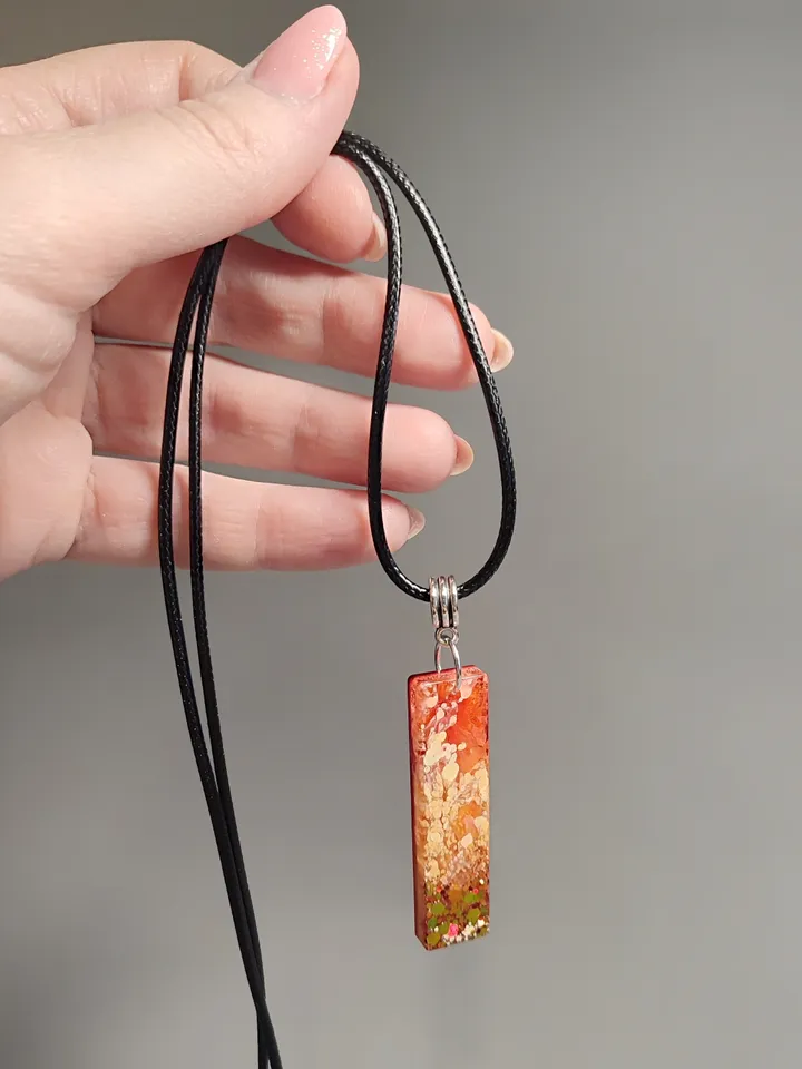 Jewelry set earrings and pendant in orange color
