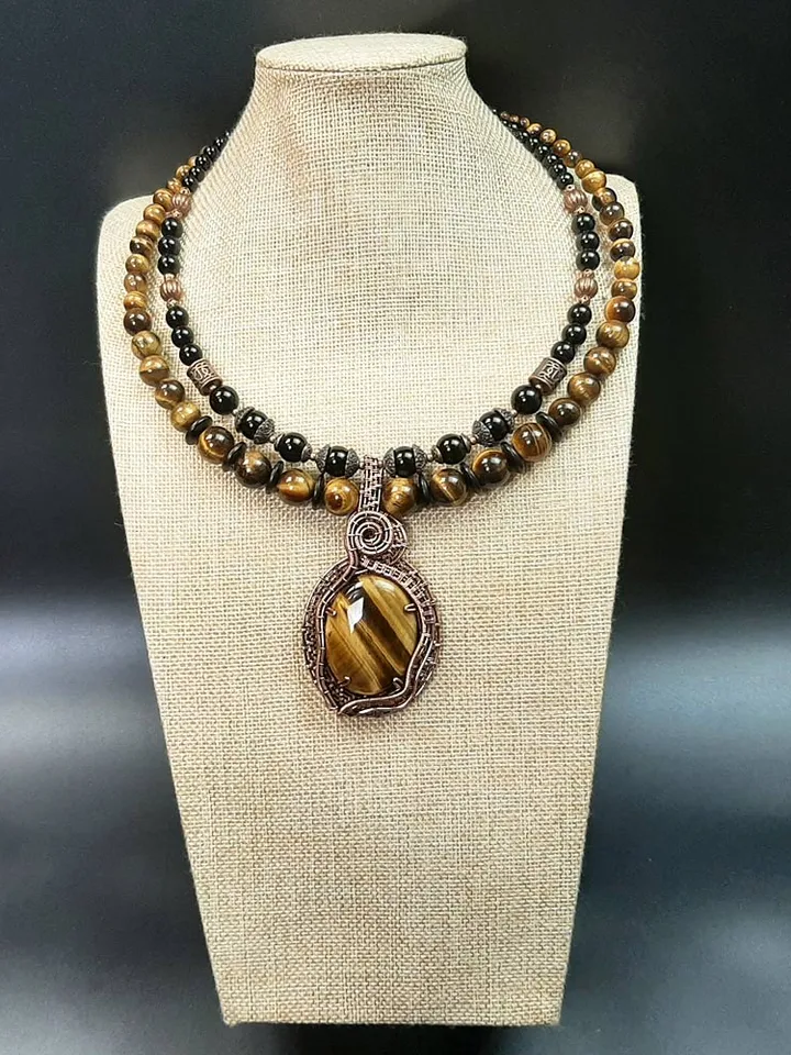 Handmade pendant made of Tiger Eye stone and copper wire.