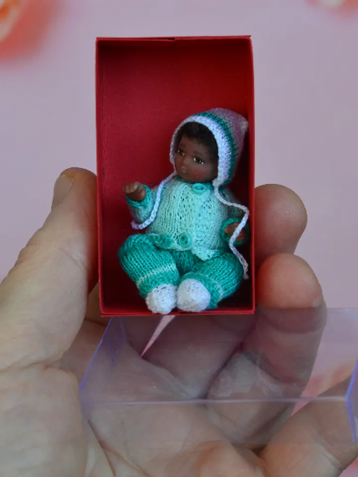 Miniature doll child in 12th scales. A baby for the dollhouse. Baby in a blue suit.