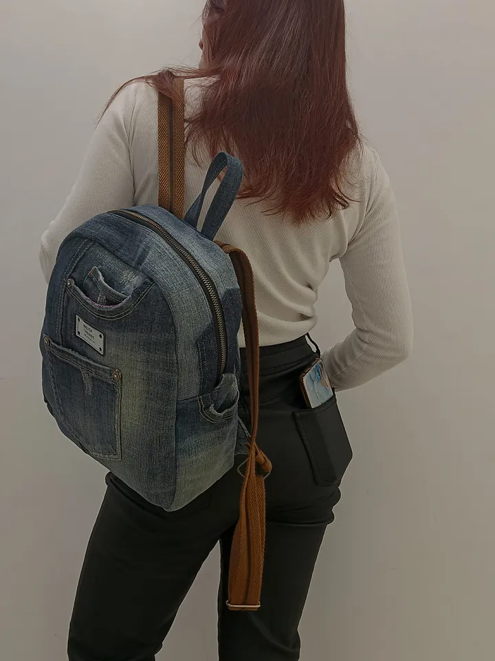 Denim backpack with 100 percent cotton lining, handmade, recycled jeans, 5 pockets on the outside, 2 deep pockets on the inside, strong webbing straps, decorated with a label and genuine leather on the zipper puller. size: height 30 cm. *25*12cm