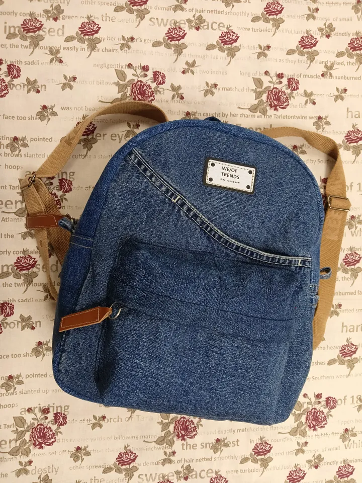 Everyday denim backpack made from recycled jeans, 3 pockets outside (1 volumetric with a zipper), 2 pockets inside (1 with a zipper) 100 percent cotton inside, strong handles made of cotton straps, leather strips on the zipper puller. decorated with a lab