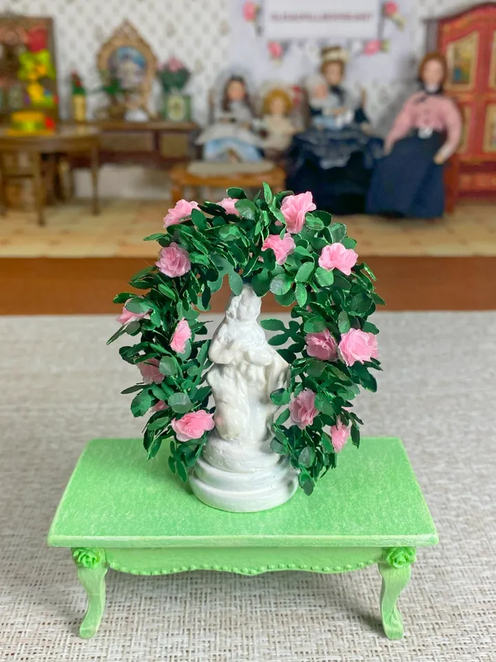 A figurine with delicate roses for a dollhouse and a park area. Dollhouse miniature. 1:12.