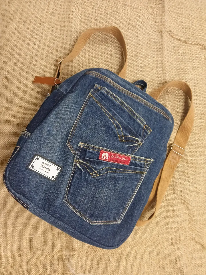 Casual unisex denim backpack made from eco-frendly recycled jeans, with 6 pockets outside and 2 pockets inside (1 with a zipper), strong belt on adjustable straps. Inside is colored cotton fabric. The back wall is quilted.