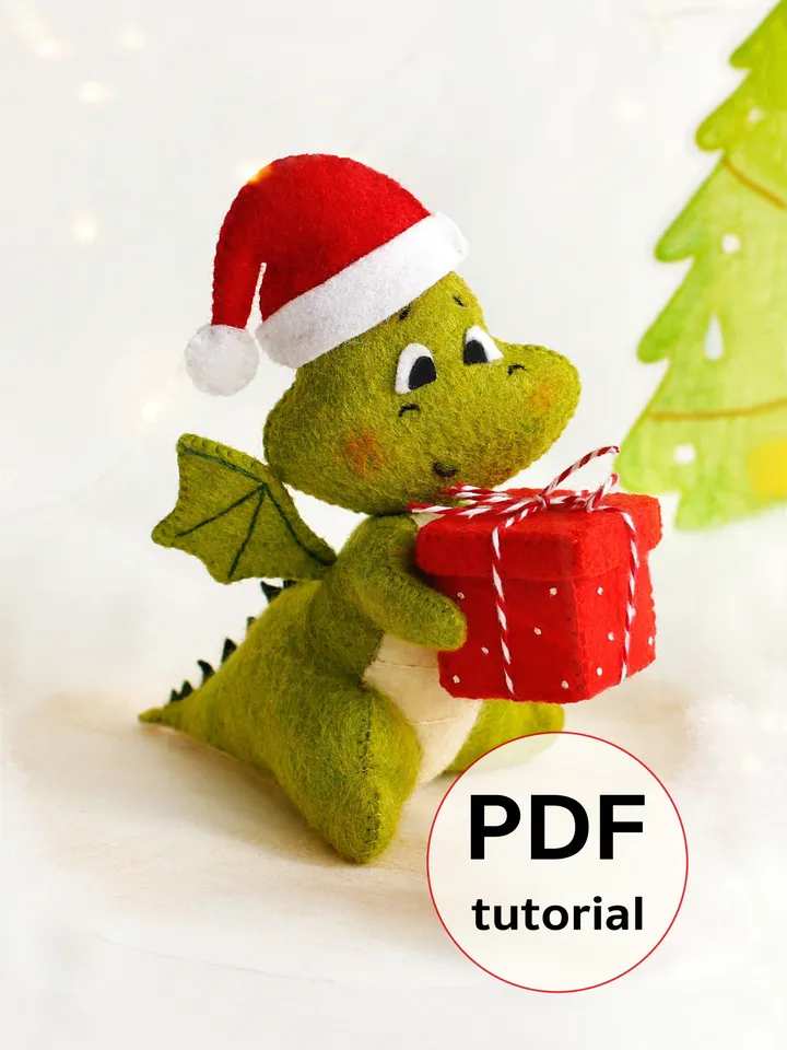 Felt green dragon with Christmas present hand sewing PDF tutorial with patterns, DIY Christmas tree ornament. Felt dinosaur toy pattern