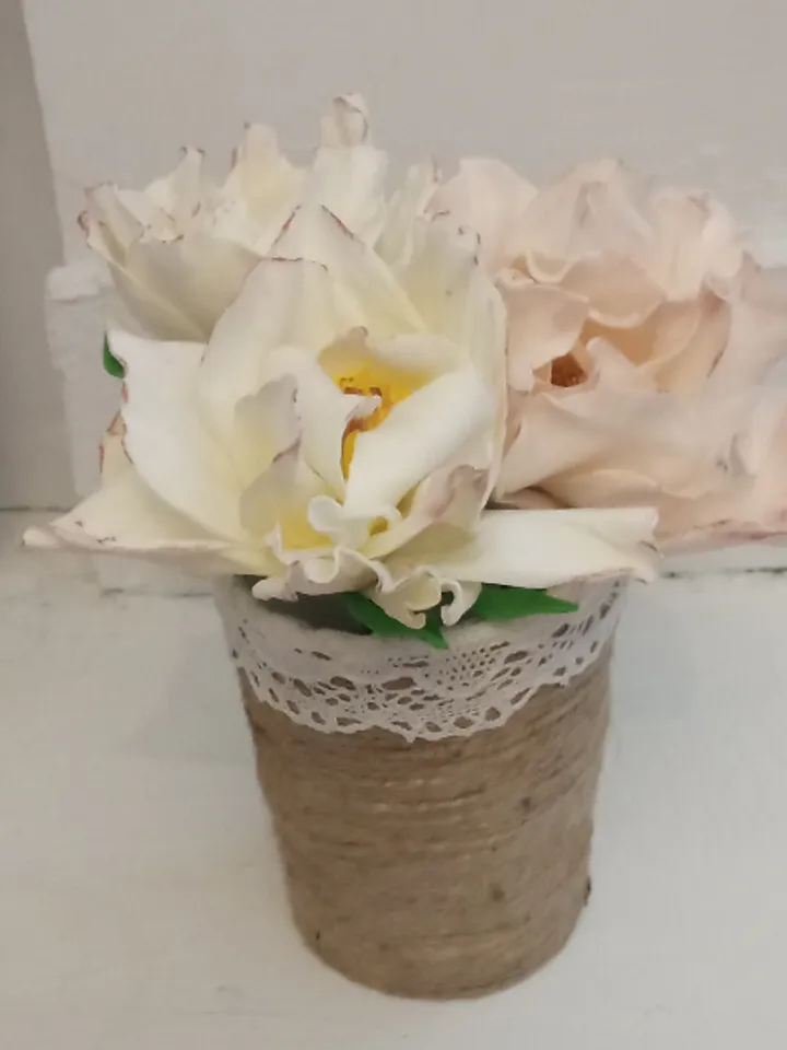 Delicate small bouquet in a jute pot