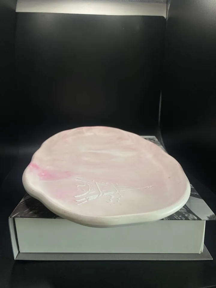 Handmade oval decorative tray made of plaster using marble pouring technique