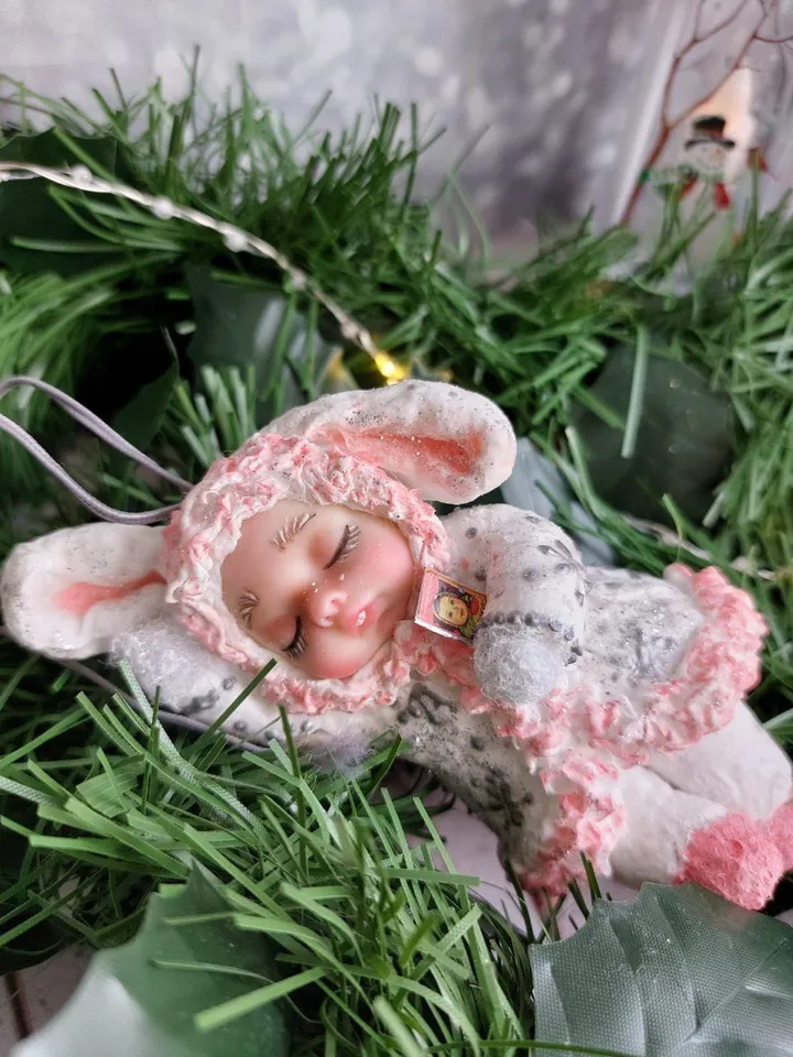 Cute Christmas tree toy made of cotton sleeping bunny. Handmade hanging toy. A gift for Christmas.