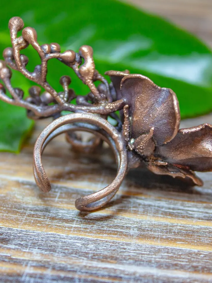 Unique handmade copper ring made from a real flower bud using the electroforming method, decorated with a Swarovski crystal