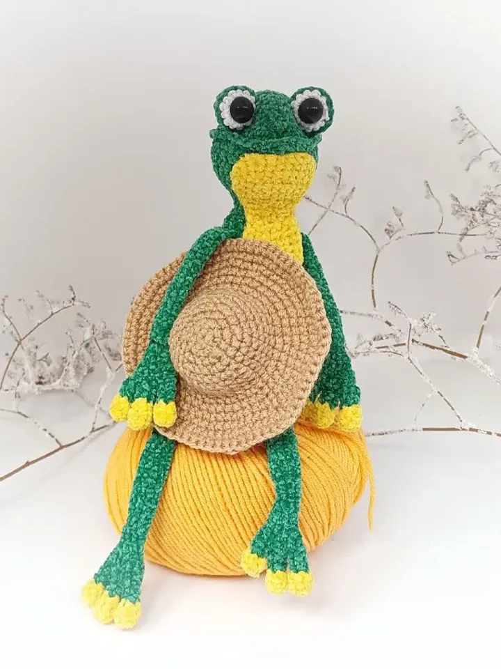 Funny soft toy frog in a hat
