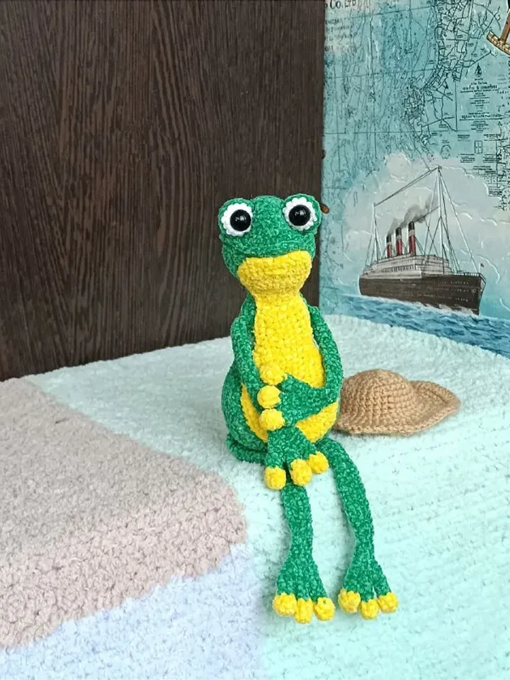 Funny soft toy frog in a hat