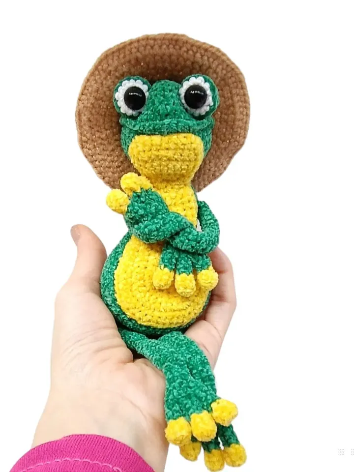 Funny soft toy frog in a hat