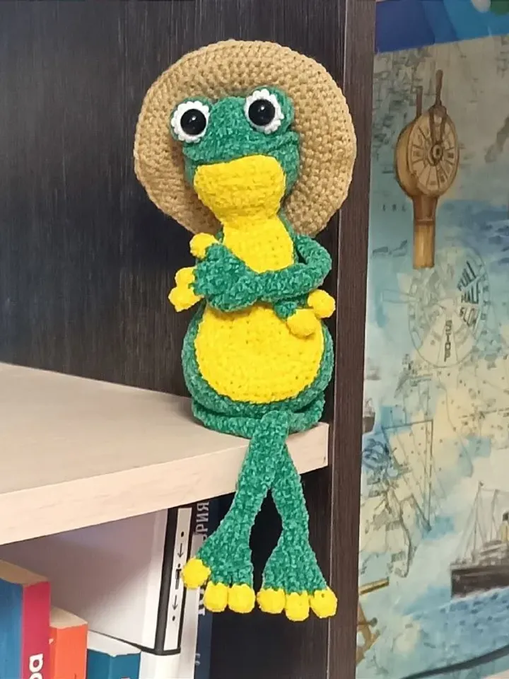 Funny soft toy frog in a hat
