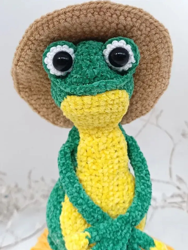Funny soft toy frog in a hat