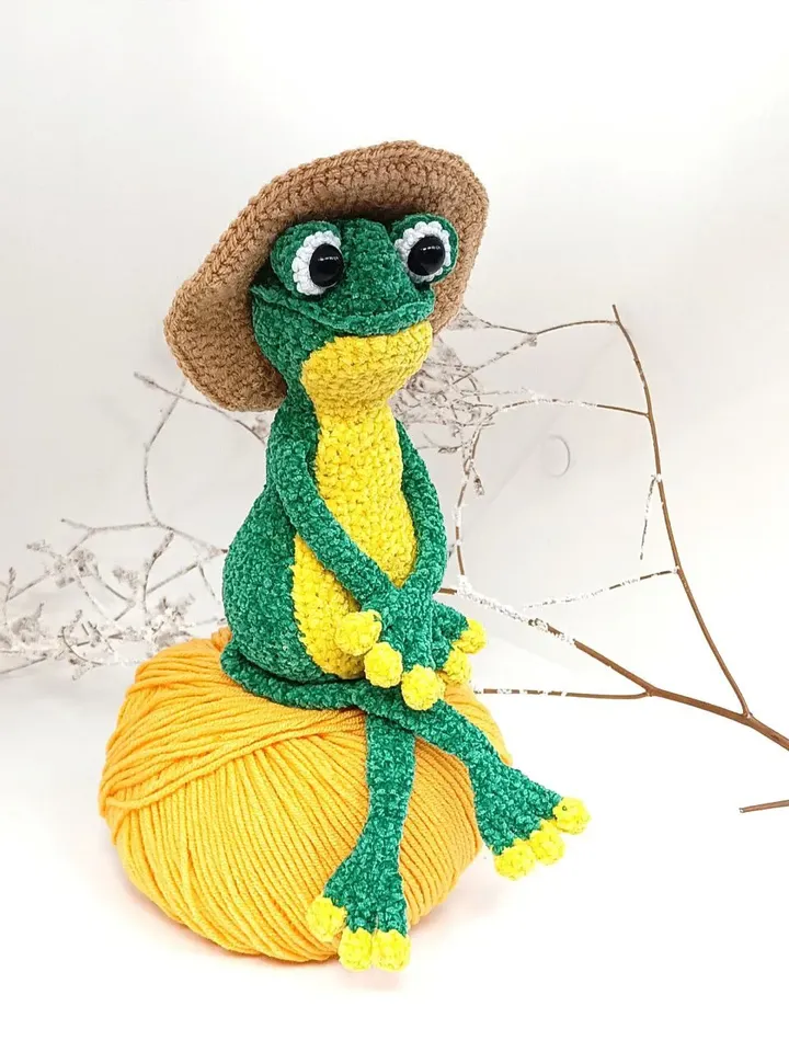 Funny soft toy frog in a hat