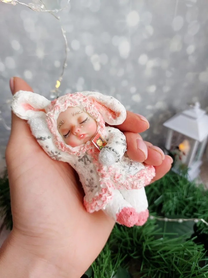 Cute Christmas tree toy made of cotton sleeping bunny. Handmade hanging toy. A gift for Christmas.