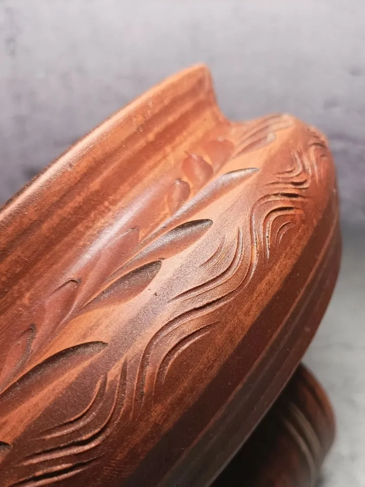 Ceramic casserole with a lid. Handmade from red clay. Carved pattern