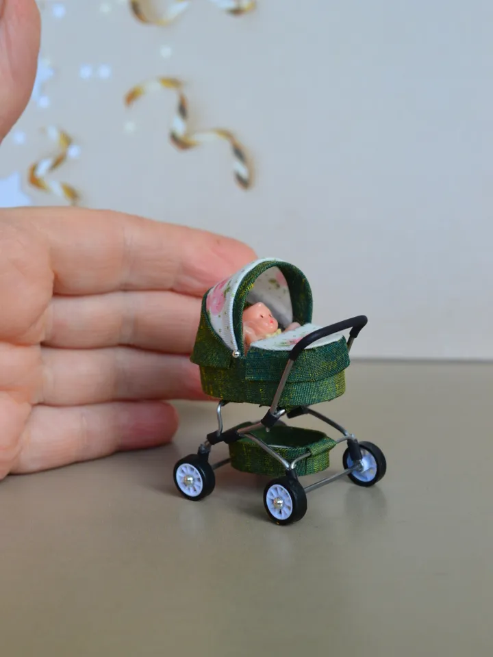 Miniature toy doll stroller in 1/24 scale. Complete with baby doll.
