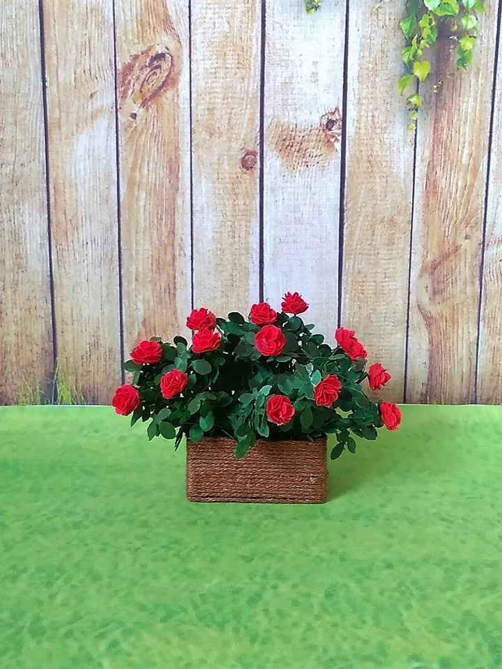 Miniature roses in a flowerpot. Dollhouse miniature.