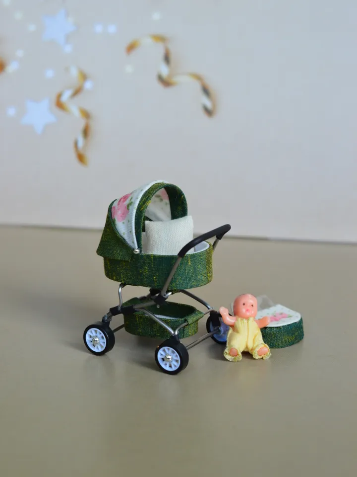 Miniature toy doll stroller in 1/24 scale. Complete with baby doll.