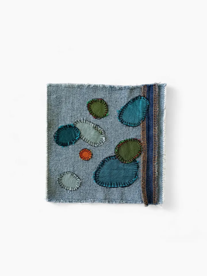 Upcycled denim/silk boro patch – visible mending.