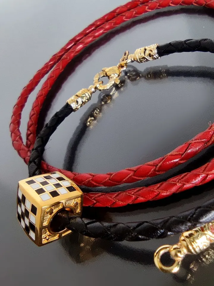 Leather braided bracelet with a chess bead. Silver, gold plated, hot enamel.