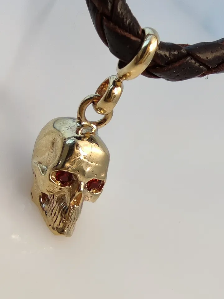 Skull pendant with inlaid natural garnets