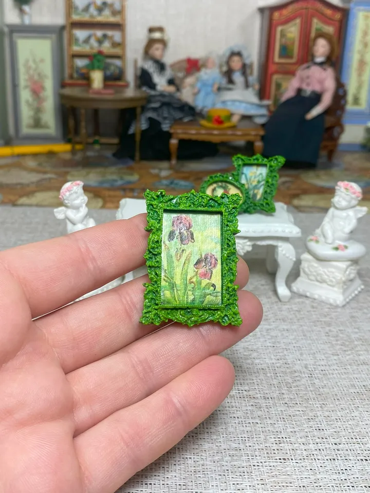 A set of frames with images of flowers. Dollhouse miniature. 1:12.