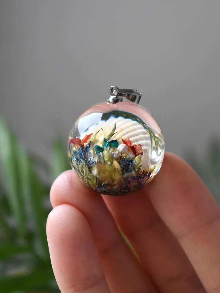 Shell with a pearl pendant. Sea pendant with shell, pearl and real flowers. Pinctada pendant.
