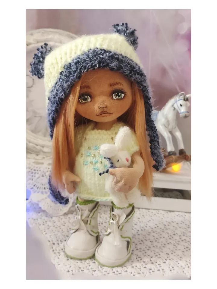 Cute little girl doll with a bunny
