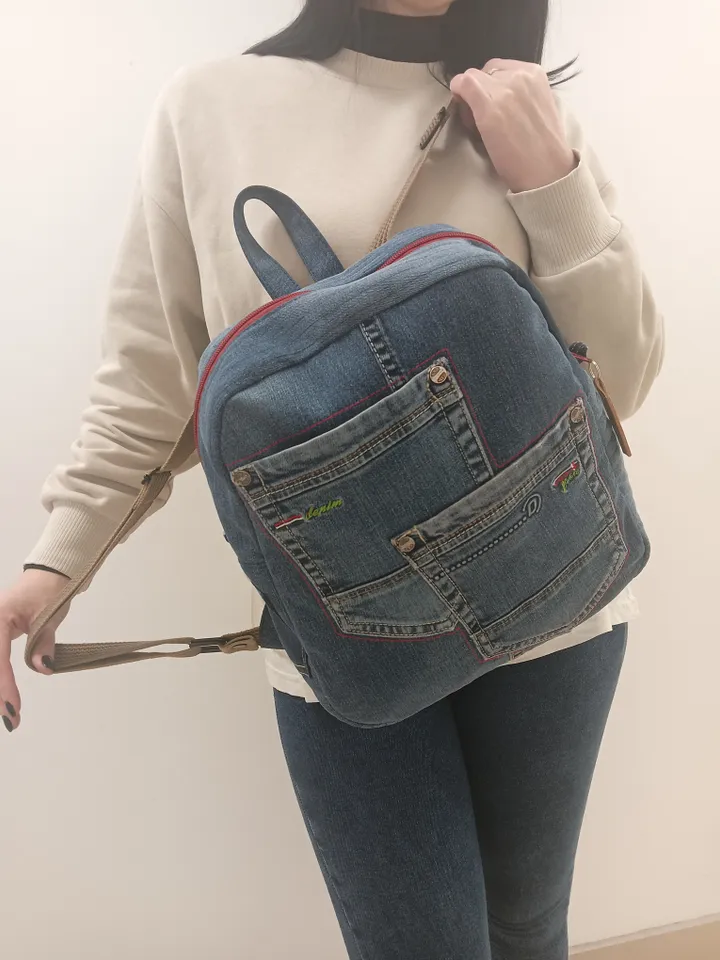 Casual unisex denim backpack made from recycled jeans, with 3 pockets outside and 3 pockets inside (1 with a zipper), strong 2-color strap on adjustable straps. Inside is synthetic fabric. The back and bottom is quilted.