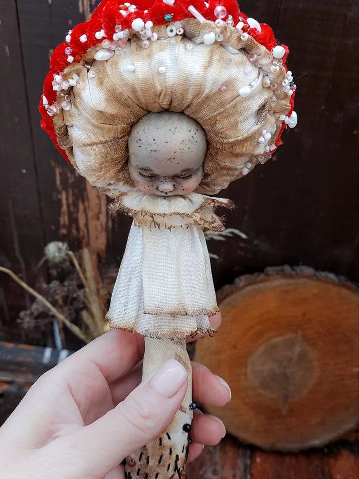 Art doll Mushroom. Unusual handmade statuette. Sleeping child-toy in the image of a fly mushroom. Mushroom is a textile sculpture. Unique statuette made of fabric and polymer clay, decorated with beads and beads. An art object for your interior and collec