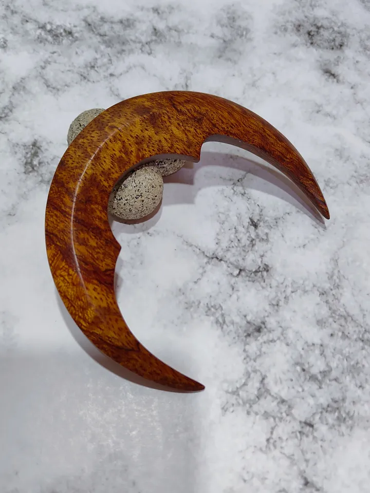 Hair bun pin in the shape of a moon.